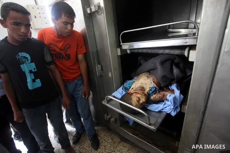 Relatives of ten-year-old Palestinian Mohammed Zohde Al-Dam mourn over his body in Gaza City 20 June 2012. Mohammed was killed and his father Zohde Al-Dam in an Israeli air strike raising to eight the number of Palestini...