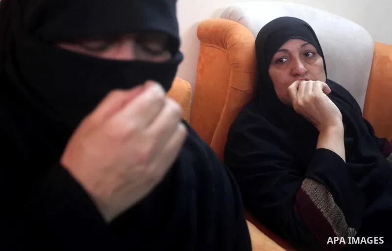 Palestinian Relatives of 14-year old Moamen al-Adam, who was killed in an Israeli air strike the day before, mourn as they watch his funeral procession in Gaza city on June 21, 2012. The latest attacks follow three days...