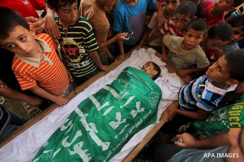 friends of 14-year old Palestinian Moamen al-Adam, who was killed in an Israeli air strike the day before, bids farewell to him during his funeral procession in Gaza city on June 21, 2012. The latest attacks follow three...