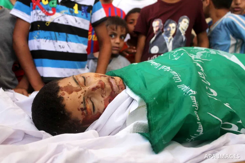 friends of 14-year old Palestinian Moamen al-Adam, who was killed in an Israeli air strike the day before, bids farewell to him during his funeral procession in Gaza city on June 21, 2012. The latest attacks follow three...