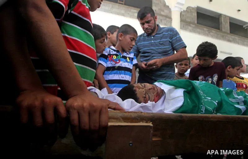 Relatives of 14-year old Palestinian Moamen al-Adam, who was killed in an Israeli air strike the day before, bids farewell to him during his funeral procession in Gaza city on June 21, 2012. The latest attacks follow thr...