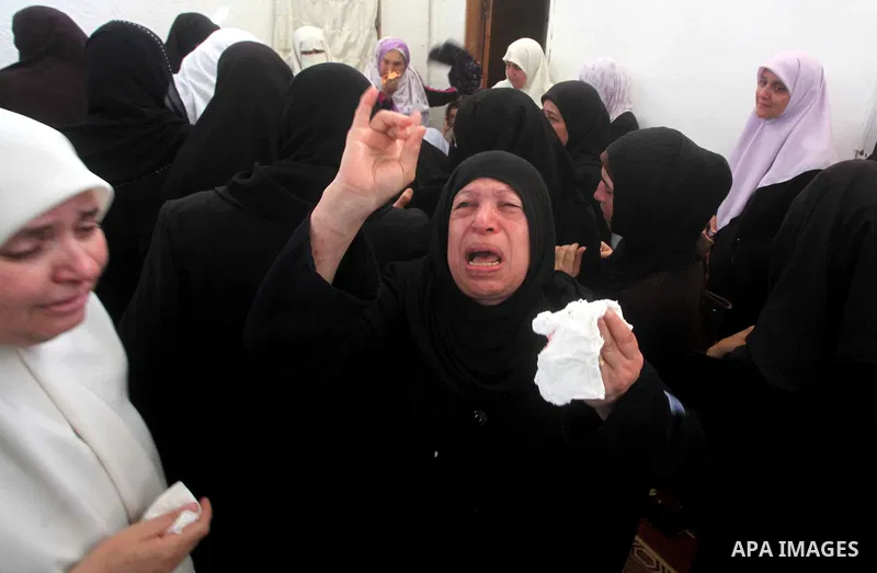 Palestinian relatives of a militant of al-Qassam brigades Thair Al-Baik, 30, mourn during his funeral in Jabalia refugee camp in the northern Gaza Strip on June 21, 2012. Al-Baik one of two fighters from al-Qassam brigad...