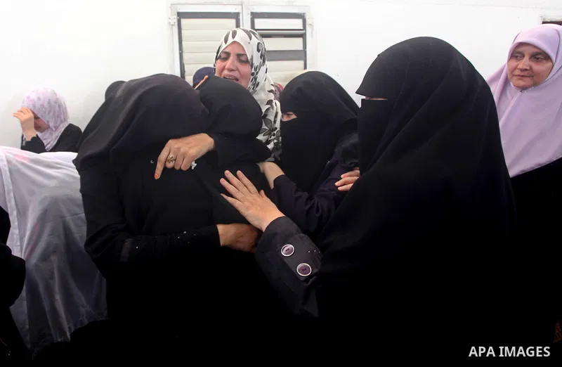 Palestinian relatives of a militant of al-Qassam brigades Thair Al-Baik, 30, mourn during his funeral in Jabalia refugee camp in the northern Gaza Strip on June 21, 2012. Al-Baik one of two fighters from al-Qassam brigad...