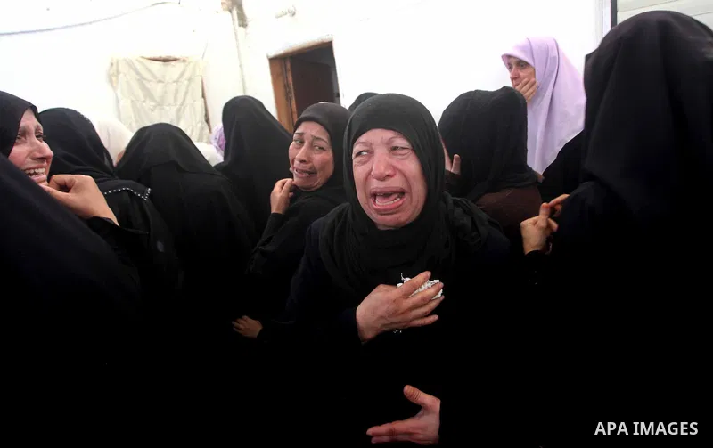 Palestinian relatives of a militant of al-Qassam brigades Thair Al-Baik, 30, mourn during his funeral in Jabalia refugee camp in the northern Gaza Strip on June 21, 2012. Al-Baik one of two fighters from al-Qassam brigad...