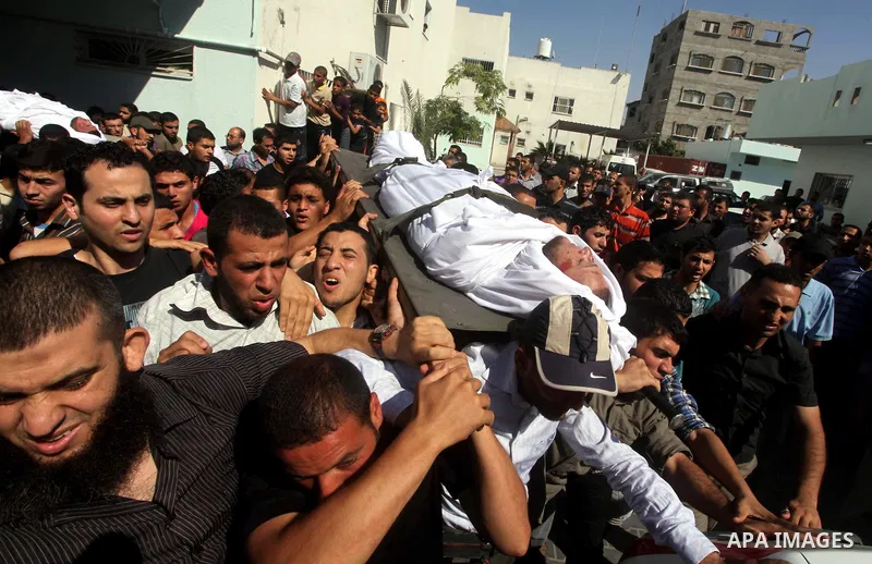 Palestinian mourners carry the bodies of militants of al-Qassam brigades Thair Al-Baik, and Mohammed al-Khaldi, during their funeral in Jabalia refugee camp in the northern Gaza Strip on June 21, 2012. Two armed wing of...