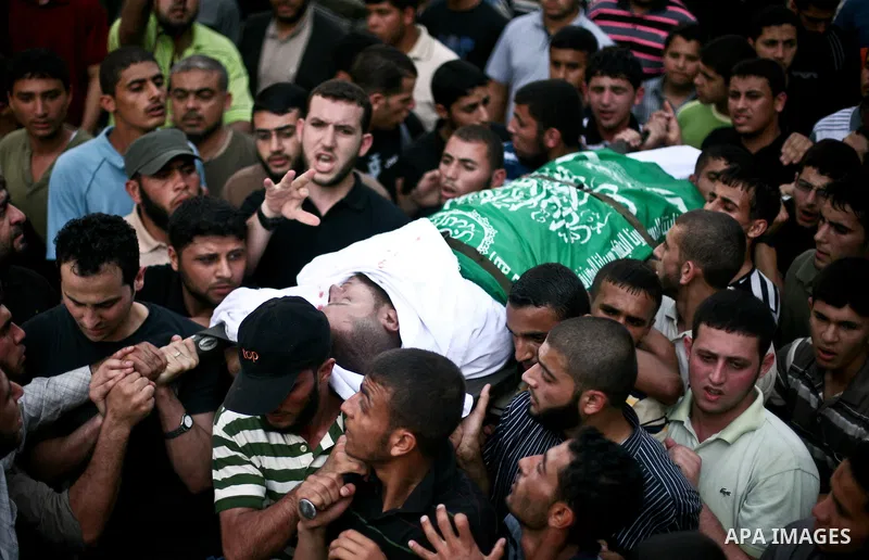 Palestinian mourners carry the body of Hamas militant Thair al-Bik, and Mohammed al-Khaldi , during their funeral in Jabaliya Refugee Camp, northern Gaza Strip, Thursday, June 21, 2012. Al-Bik and Al-Khaldi two Hamas mil...