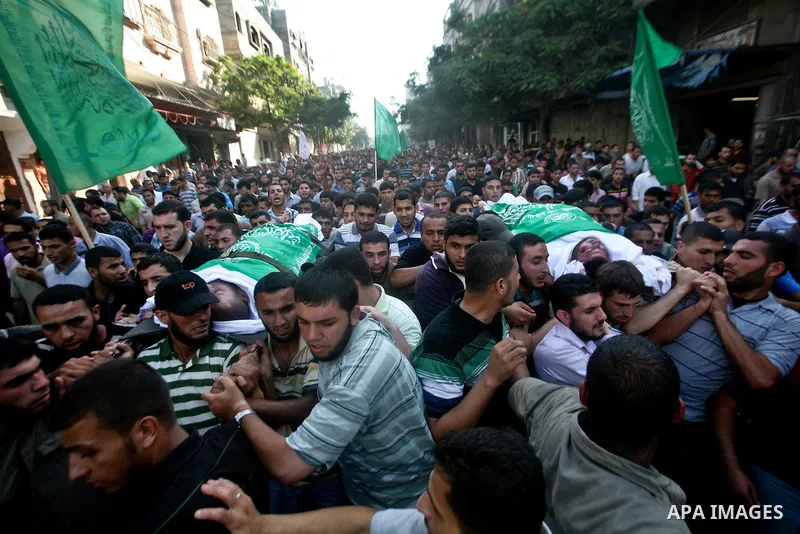 Palestinian mourners carry the body of Hamas militant Thair al-Bik, and Mohammed al-Khaldi , during their funeral in Jabaliya Refugee Camp, northern Gaza Strip, Thursday, June 21, 2012. Al-Bik and Al-Khaldi two Hamas mil...