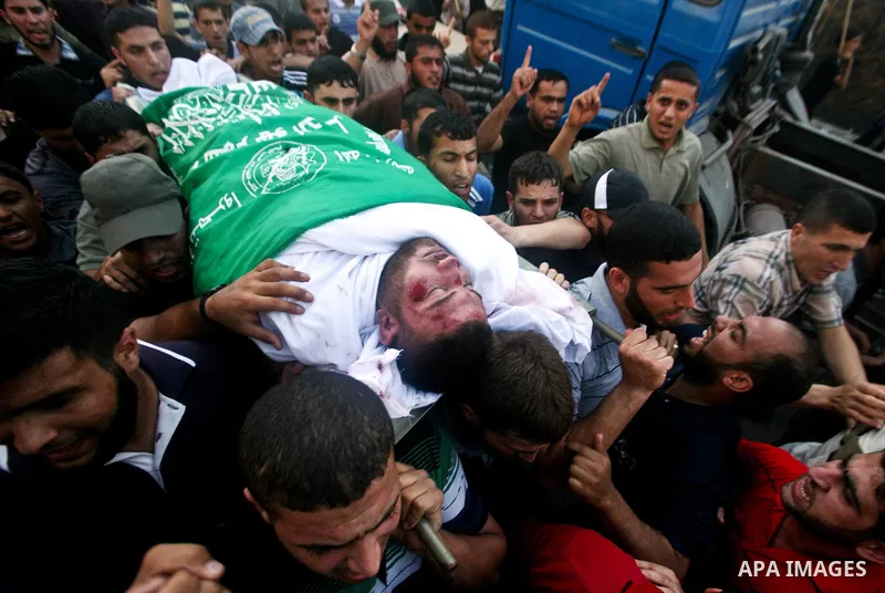 Palestinian mourners carry the body of Hamas militant Thair al-Bik, and Mohammed al-Khaldi , during their funeral in Jabaliya Refugee Camp, northern Gaza Strip, Thursday, June 21, 2012. Al-Bik and Al-Khaldi two Hamas mil...