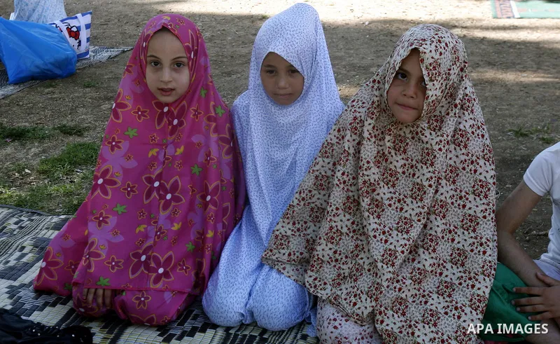 Palestinian girls read the Holy Quran during the summer camps at Al-Aqsa mosque in the old city of Jerusalem on 21 June 2012. Photo by Mahfouz Abu Turk.