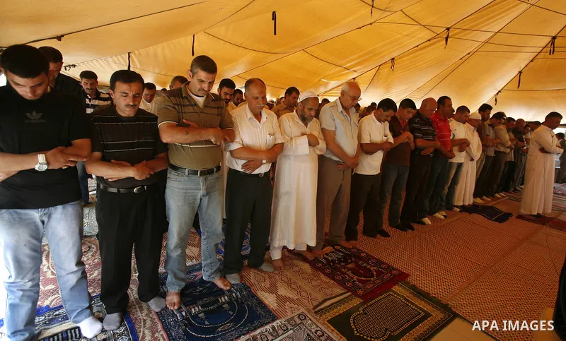 Palestinian Muslim worshippers attend Friday prayers outside a protest tent against the continuing 'Judaization of Jerusalem' by Jewish settlers, in the mostly Arab neighbourhood of Silwan in east Jerusalem on June 22, 2...