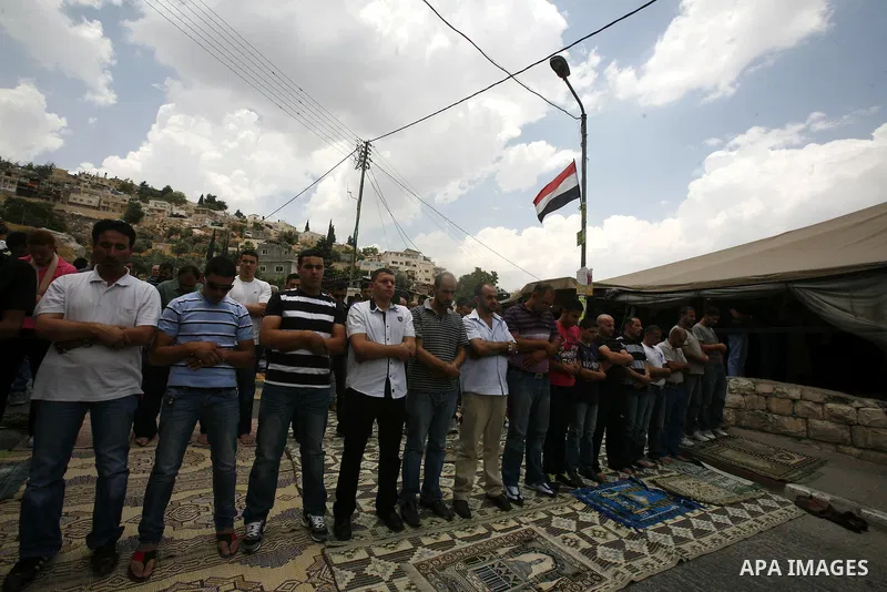 Palestinian Muslim worshippers attend Friday prayers outside a protest tent against the continuing 'Judaization of Jerusalem' by Jewish settlers, in the mostly Arab neighbourhood of Silwan in east Jerusalem on June 22, 2...