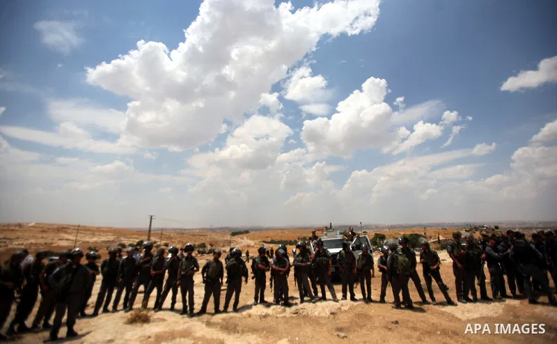 Israeli policemen stand guards during a protest in the southern West Bank village of Susia near Hebron city on June 22, 2012 where Israel has recently served orders to evacuate and demolish 50 structures comprising the h...