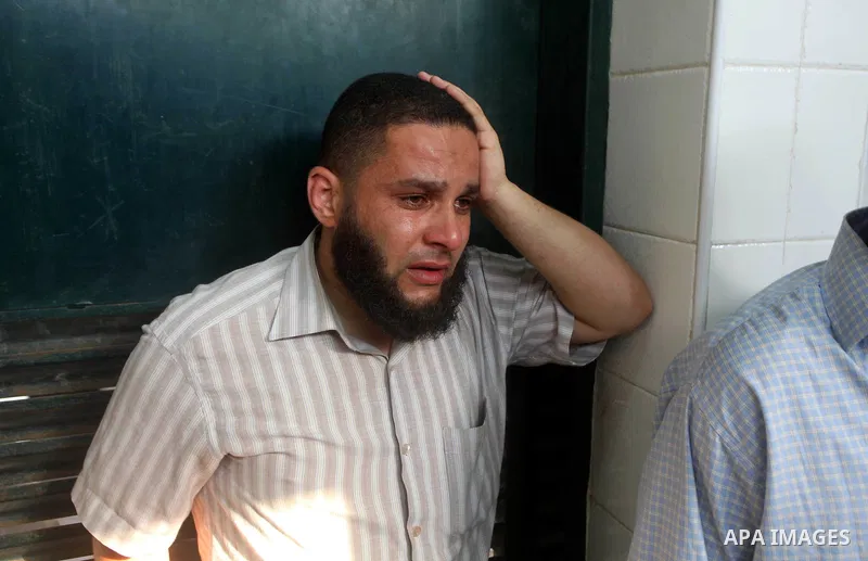 Relatives of wounded Palestinians mourn, at al-Aqsa hospital following an Israeli airstrike east of Bureij refugee camp, in Deir Al Balah, central Gaza strip, Friday, June 22, 2012. An Israeli air strike killed a Palesti...