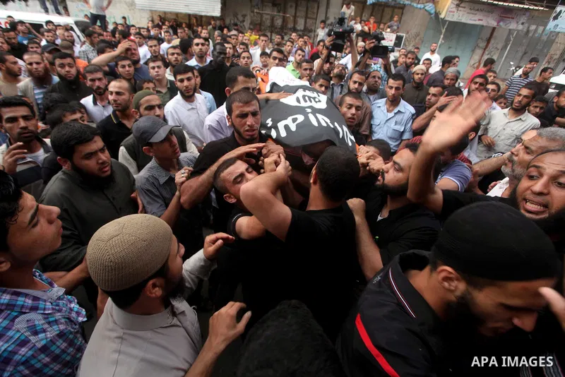 Palestinian mourners carry the body of militant Basil Ahmad during his funeral in Bureij refugee camp, central Gaza Strip, Friday, June 22, 2012. Palestinian sources say that Ahmad was killed during an Israeli airstrike...
