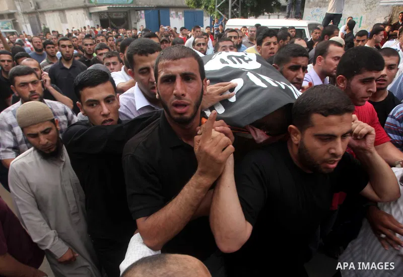 Palestinian mourners carry the body of militant Basil Ahmad during his funeral in Bureij refugee camp, central Gaza Strip, Friday, June 22, 2012. Palestinian sources say that Ahmad was killed during an Israeli airstrike...