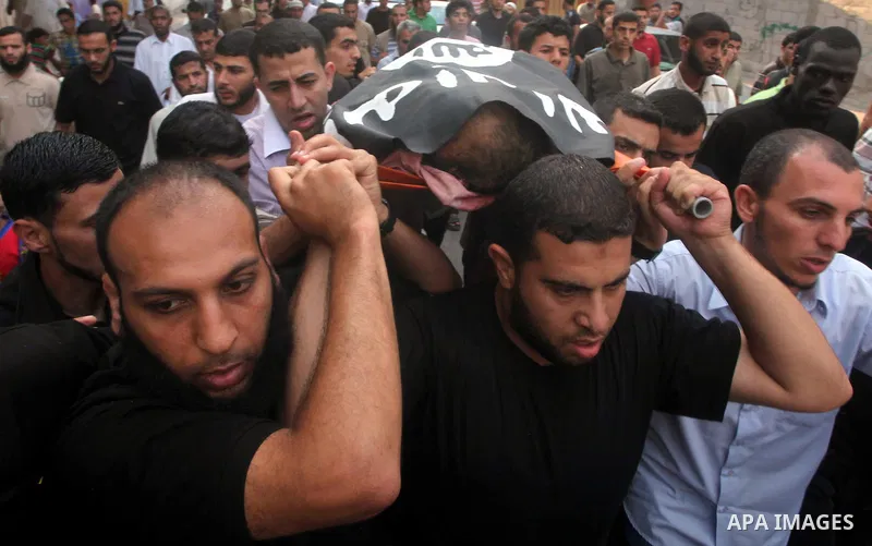 Palestinian mourners carry the body of militant Basil Ahmad during his funeral in Bureij refugee camp, central Gaza Strip, Friday, June 22, 2012. Palestinian sources say that Ahmad was killed during an Israeli airstrike...