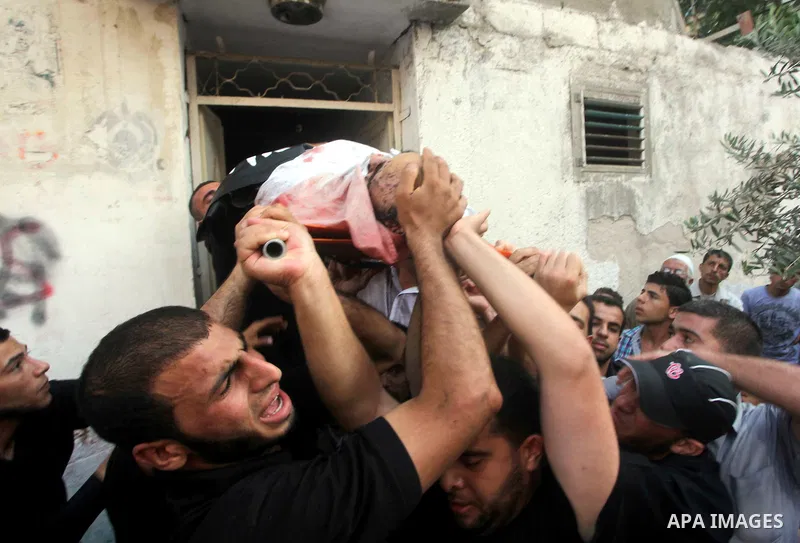 Palestinian mourners carry the body of militant Basil Ahmad during his funeral in Bureij refugee camp, central Gaza Strip, Friday, June 22, 2012. Palestinian sources say that Ahmad was killed during an Israeli airstrike...