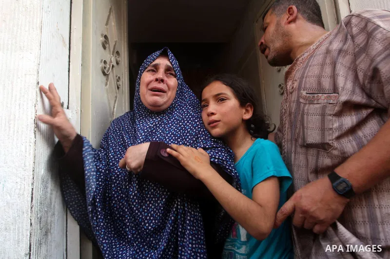 Relatives of Palestinian militant Basil Ahmed mourn during his funeral in Bureij refugee camp, central Gaza Strip, Friday, June 22, 2012. Palestinian sources say that Ahmad was killed during an Israeli airstrike east of...