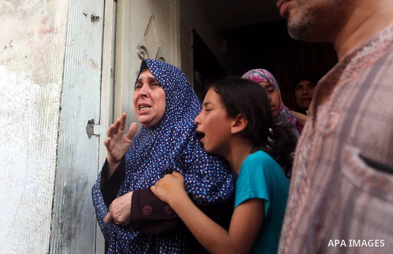 Relatives of Palestinian militant Basil Ahmed mourn during his funeral in Bureij refugee camp, central Gaza Strip, Friday, June 22, 2012. Palestinian sources say that Ahmad was killed during an Israeli airstrike east of...