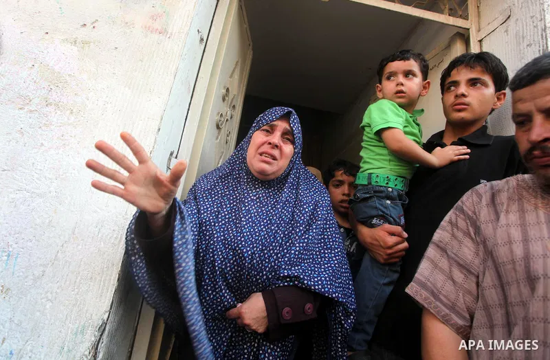 Relatives of Palestinian militant Basil Ahmed mourn during his funeral in Bureij refugee camp, central Gaza Strip, Friday, June 22, 2012. Palestinian sources say that Ahmad was killed during an Israeli airstrike east of...