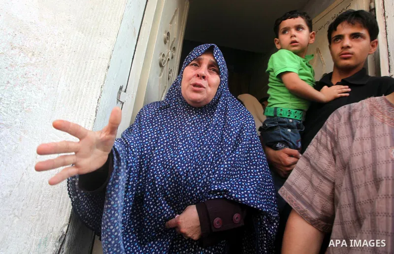 Relatives of Palestinian militant Basil Ahmed mourn during his funeral in Bureij refugee camp, central Gaza Strip, Friday, June 22, 2012. Palestinian sources say that Ahmad was killed during an Israeli airstrike east of...