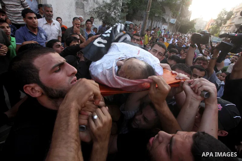 Palestinian mourners carry the body of militant Basil Ahmad during his funeral in Bureij refugee camp, central Gaza Strip, Friday, June 22, 2012. Palestinian sources say that Ahmad was killed during an Israeli airstrike...