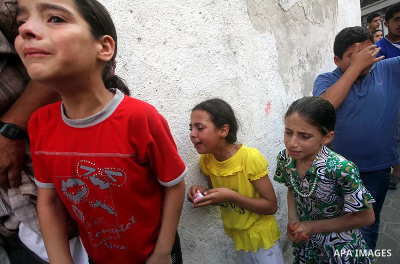 Relatives of Palestinian militant Basil Ahmed mourn during his funeral in Bureij refugee camp, central Gaza Strip, Friday, June 22, 2012. Palestinian sources say that Ahmad was killed during an Israeli airstrike east of...