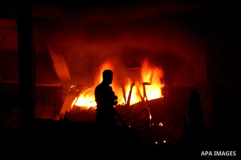Hamas Police and firemen look at the damages and try to put out a fire at the al-Saraya Security complex following an Israeli air strike on Gaza on June 23, 2012. Israel launched more air strikes against on the Gaza Stri...