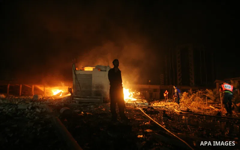 Hamas Police and firemen look at the damages and try to put out a fire at the al-Saraya Security complex following an Israeli air strike on Gaza on June 23, 2012. Israel launched more air strikes against on the Gaza Stri...