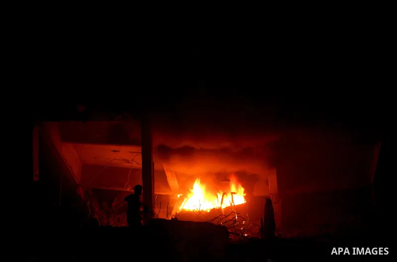 Hamas Police and firemen look at the damages and try to put out a fire at the al-Saraya Security complex following an Israeli air strike on Gaza on June 23, 2012. Israel launched more air strikes against on the Gaza Stri...