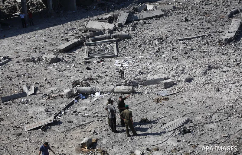 Palestinian Hamas security personnel inspect the damage at al-Saraya Security complex in the centre of Gaza City on June 23, 2012 as Israel launched fresh air strikes on the Gaza Strip overnight after killing two people...
