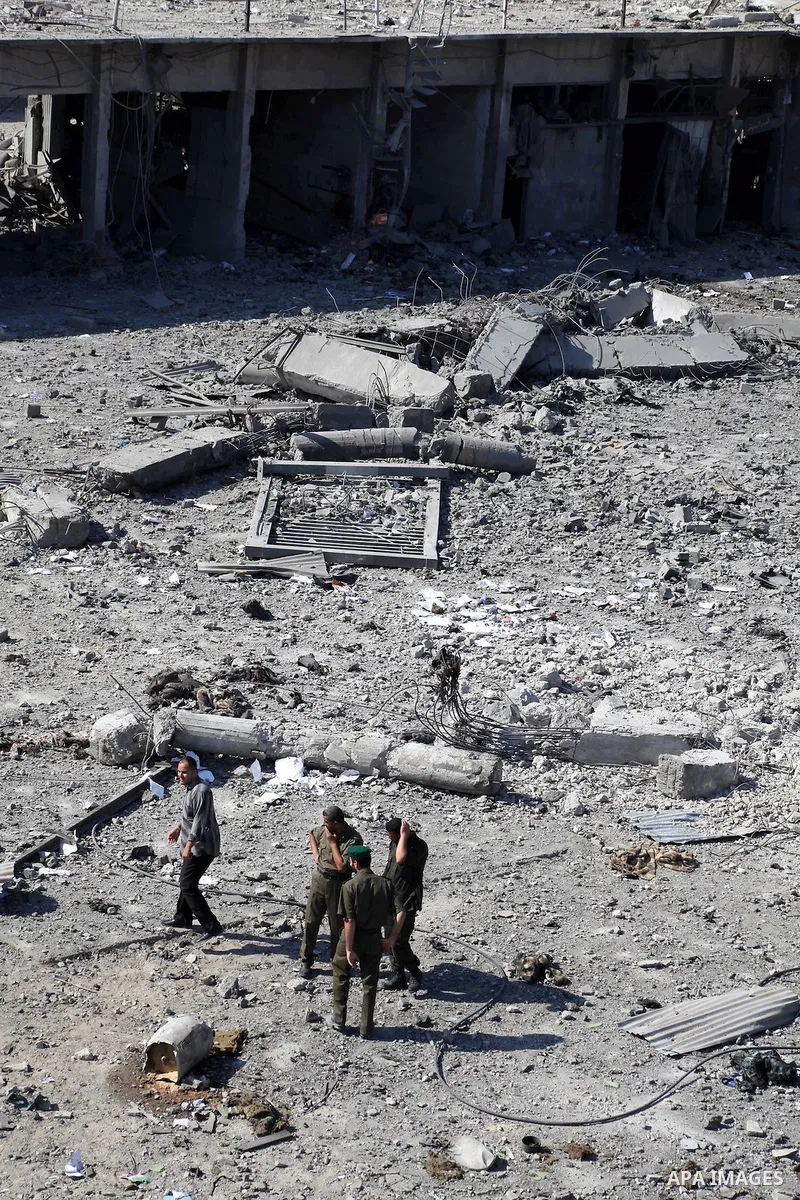 Palestinian Hamas security personnel inspect the damage at al-Saraya Security complex in the centre of Gaza City on June 23, 2012 as Israel launched fresh air strikes on the Gaza Strip overnight after killing two people...