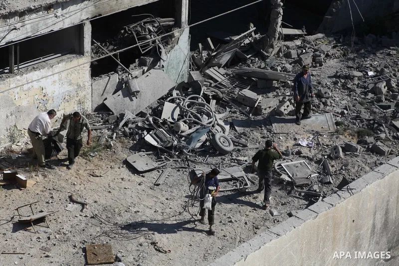 Palestinian Hamas security personnel inspect the damage at al-Saraya Security complex in the centre of Gaza City on June 23, 2012 as Israel launched fresh air strikes on the Gaza Strip overnight after killing two people...