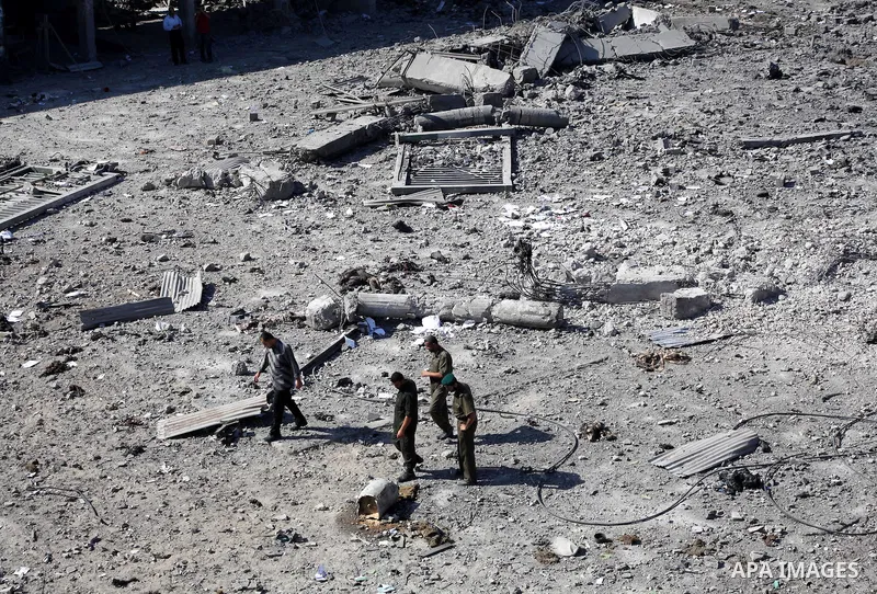 Palestinian Hamas security personnel inspect the damage at al-Saraya Security complex in the centre of Gaza City on June 23, 2012 as Israel launched fresh air strikes on the Gaza Strip overnight after killing two people...