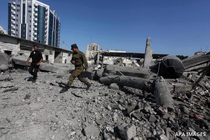 Palestinian Hamas security personnel inspect the damage at al-Saraya Security complex in the centre of Gaza City on June 23, 2012 as Israel launched fresh air strikes on the Gaza Strip overnight after killing two people...