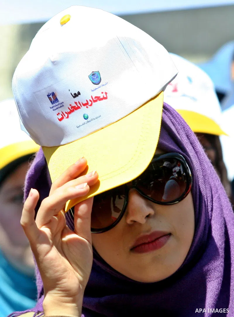 Palestinians wearing hats with the slogan " no for drugs" march in the streets of the West Bank city of Nablus on June 23, 2012 as part of an awareness campaign, entitled "fighting drug", against the consumption of narco...