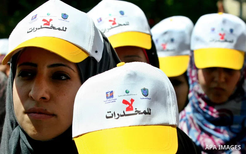 Palestinians wearing hats with the slogan " no for drugs" march in the streets of the West Bank city of Nablus on June 23, 2012 as part of an awareness campaign, entitled "fighting drug", against the consumption of narco...