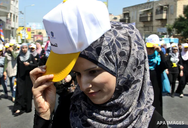 Palestinians wearing hats with the slogan " no for drugs" march in the streets of the West Bank city of Nablus on June 23, 2012 as part of an awareness campaign, entitled "fighting drug", against the consumption of narco...