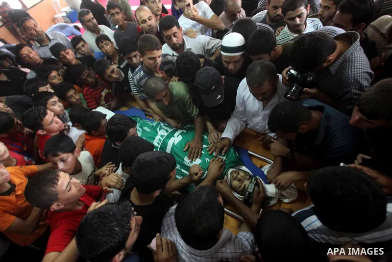 Palestinians carry the body of Hamas militant Hamam Abu Qadus during his funeral in Gaza City June 23, 2012. Israel launched air raids early on Saturday against three Hamas security targets in the Gaza Strip, wounding at...