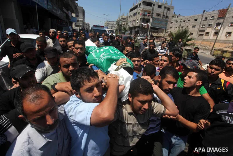 Palestinians carry the body of Hamas militant Hamam Abu Qadus during his funeral in Gaza City June 23, 2012. Israel launched air raids early on Saturday against three Hamas security targets in the Gaza Strip, wounding at...