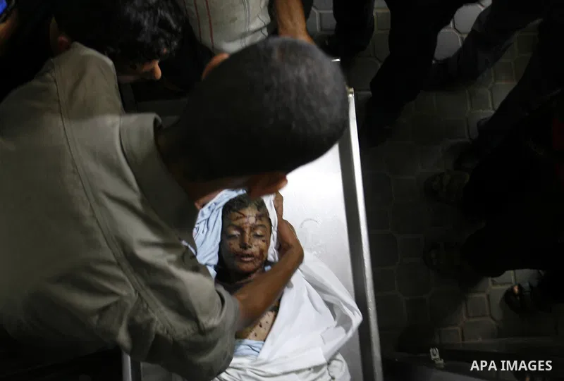 The body of a Palestinian six-year-old boy Ali Al-Shwaf is shown to the media as they prepare his body for burial at the Nasser hospital morgue in Khan Younis, in the southern Gaza Strip June 23, 2012. Hamas medical offi...