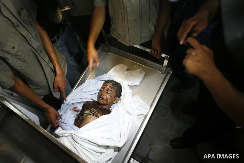 The body of a Palestinian six-year-old boy Ali Al-Shwaf is shown to the media as they prepare his body for burial at the Nasser hospital morgue in Khan Younis, in the southern Gaza Strip June 23, 2012. Hamas medical offi...