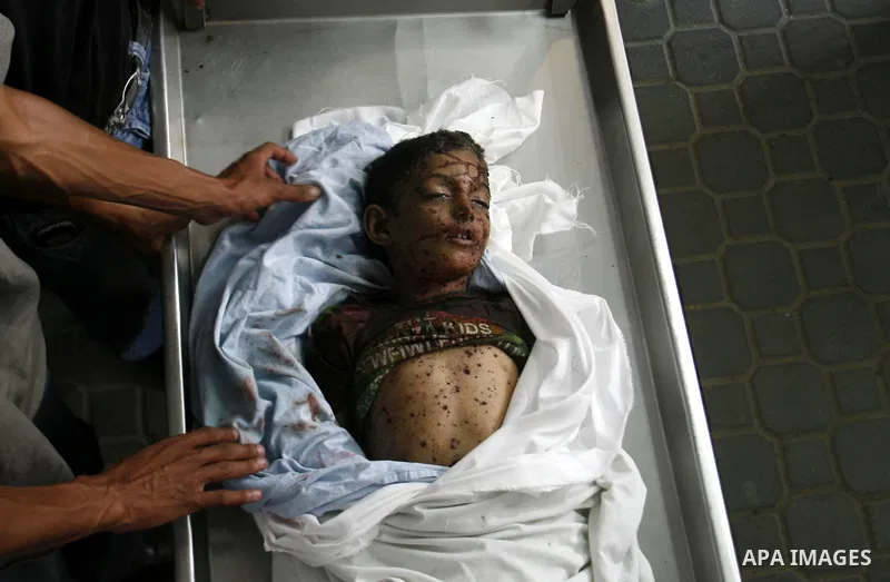 The body of a Palestinian six-year-old boy Ali Al-Shwaf is shown to the media as they prepare his body for burial at the Nasser hospital morgue in Khan Younis, in the southern Gaza Strip June 23, 2012. Hamas medical offi...