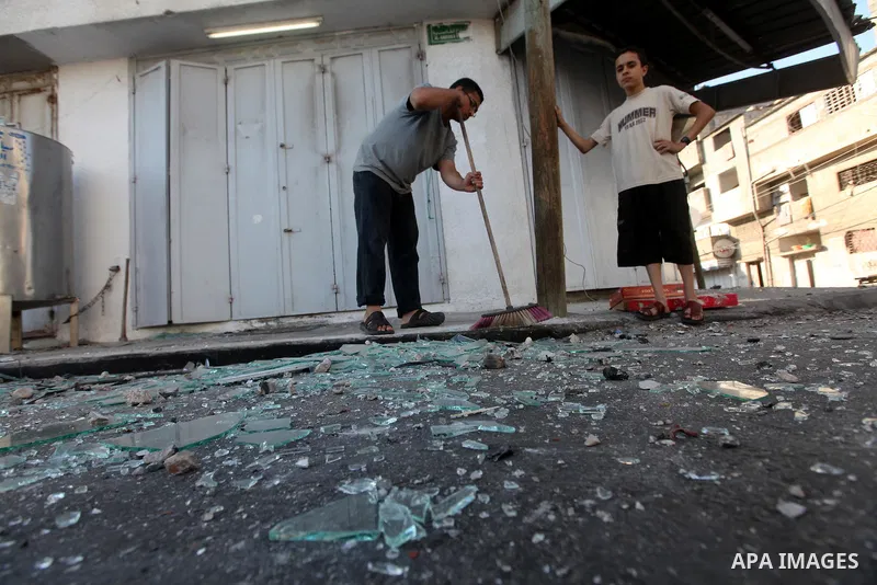 Palestinians inspect the damage in his shop near al-Saraya Security complex in the centre of Gaza City on June 23, 2012 as Israel launched fresh air strikes on the Gaza Strip overnight after killing two people in earlier...