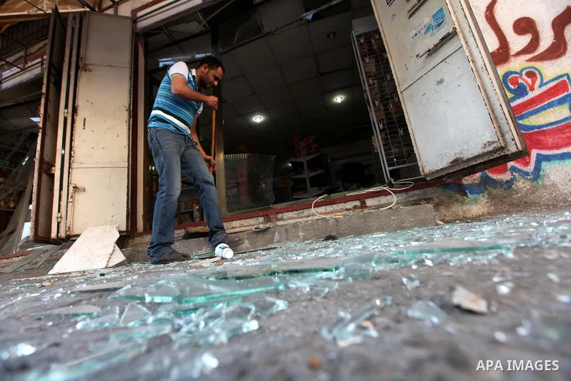 A Palestinian man inspects the damage in his shop near al-Saraya Security complex in the centre of Gaza City on June 23, 2012 as Israel launched fresh air strikes on the Gaza Strip overnight after killing two people in e...