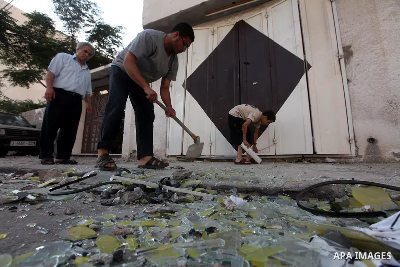 Palestinians inspect the damage in his shop near al-Saraya Security complex in the centre of Gaza City on June 23, 2012 as Israel launched fresh air strikes on the Gaza Strip overnight after killing two people in earlier...