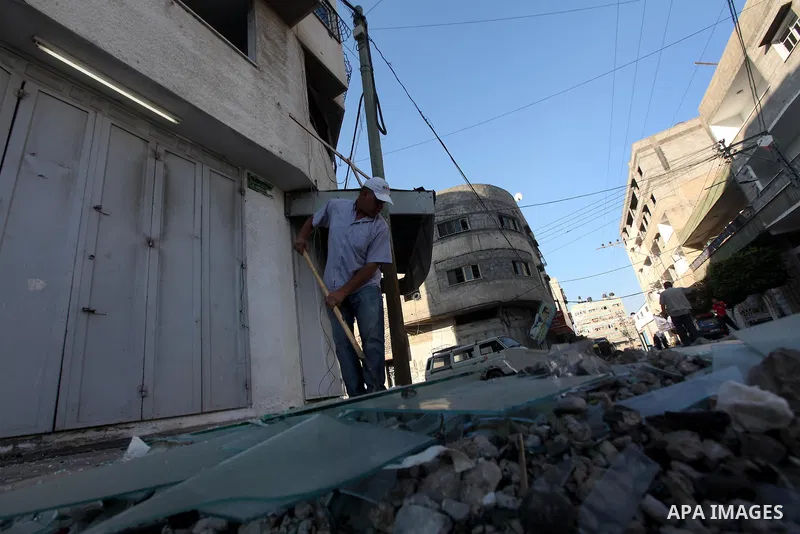 A Palestinian man inspects the damage in his shop near al-Saraya Security complex in the centre of Gaza City on June 23, 2012 as Israel launched fresh air strikes on the Gaza Strip overnight after killing two people in e...