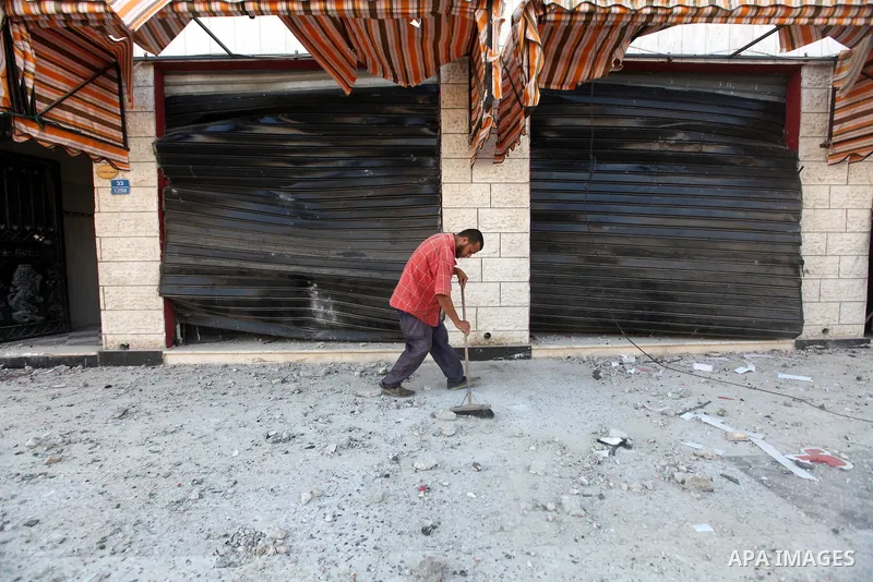 A Palestinian man inspects the damage in his shop near al-Saraya Security complex in the centre of Gaza City on June 23, 2012 as Israel launched fresh air strikes on the Gaza Strip overnight after killing two people in e...