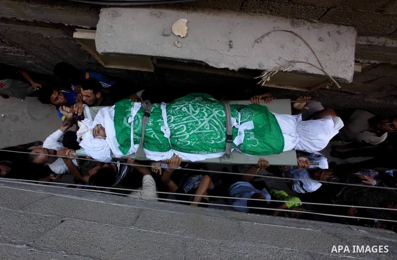 Palestinian mourners carry the body of Khaled al-Burai, 25-years-old, killed in an Israeli drone strike, during his funeral in the Jabalia refugee camp in the northern Gaza Strip on June 23, 2012. The armed wing of Hamas...