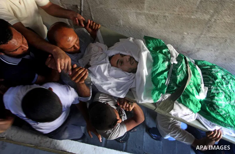 Palestinian mourners carry the body of Khaled al-Burai, 25-years-old, killed in an Israeli drone strike, during his funeral in the Jabalia refugee camp in the northern Gaza Strip on June 23, 2012. The armed wing of Hamas...
